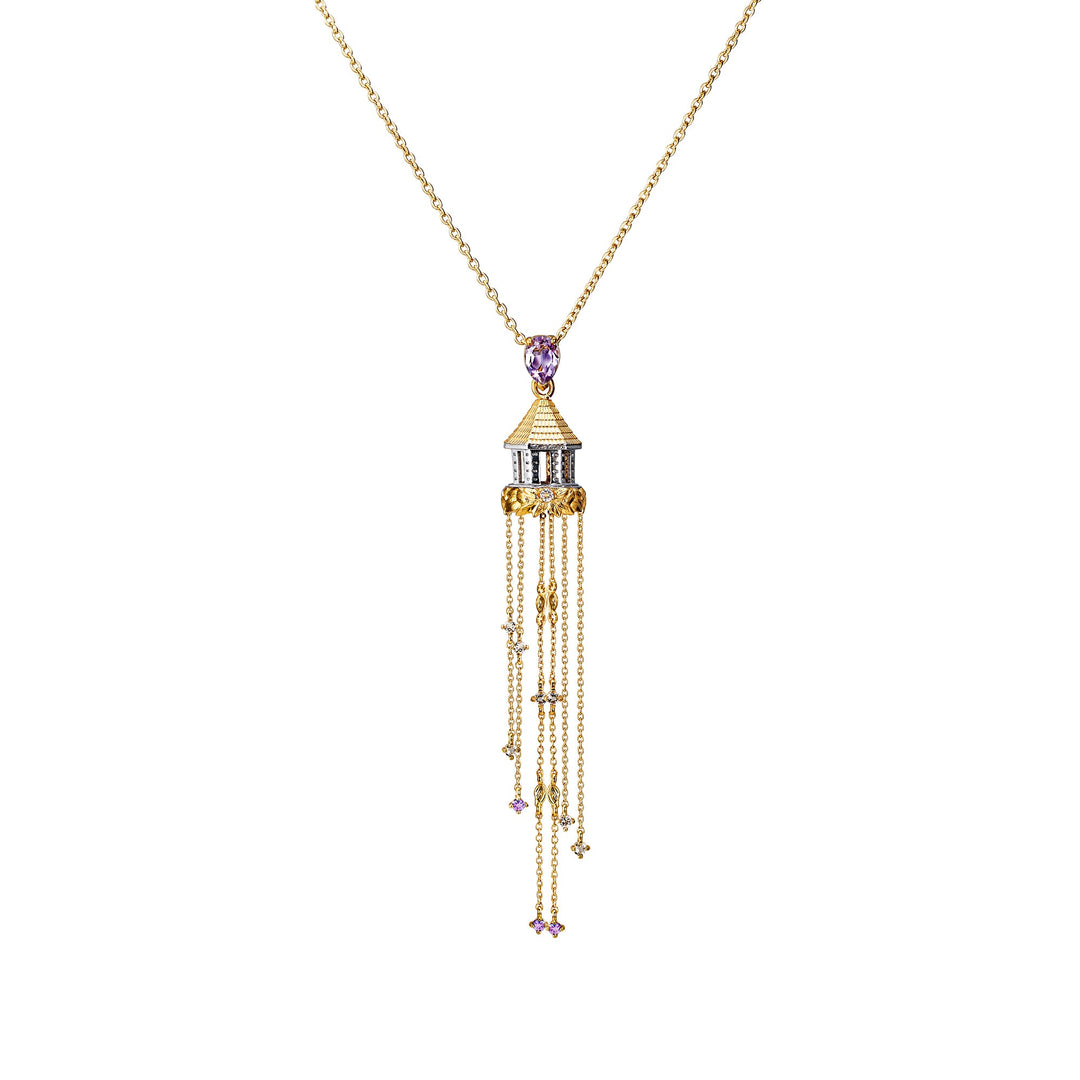 Risis Botanique Bandstand Necklace - A golden necklace with a pendant shaped like a pagoda featuring purple gemstones. Delicate chains dangle from the structure, accented by small purple stones.