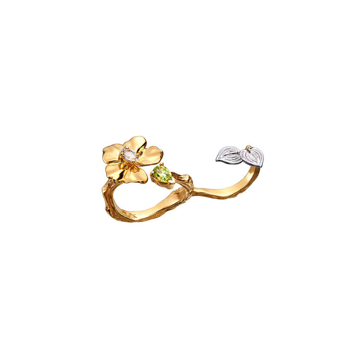 Risis Botanique Orchid Ring - A golden ring, textured like branches, features a prominent gold flower with a central gem and a smaller side flower with gem-studded petals.