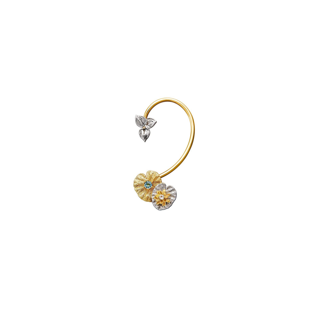 Risis Botanique Water Lily Ear Cuff - A delicate, golden hoop earring features two floral charms—one gold with a blue center, the other silver with a yellow center—and a petite, silver butterfly.