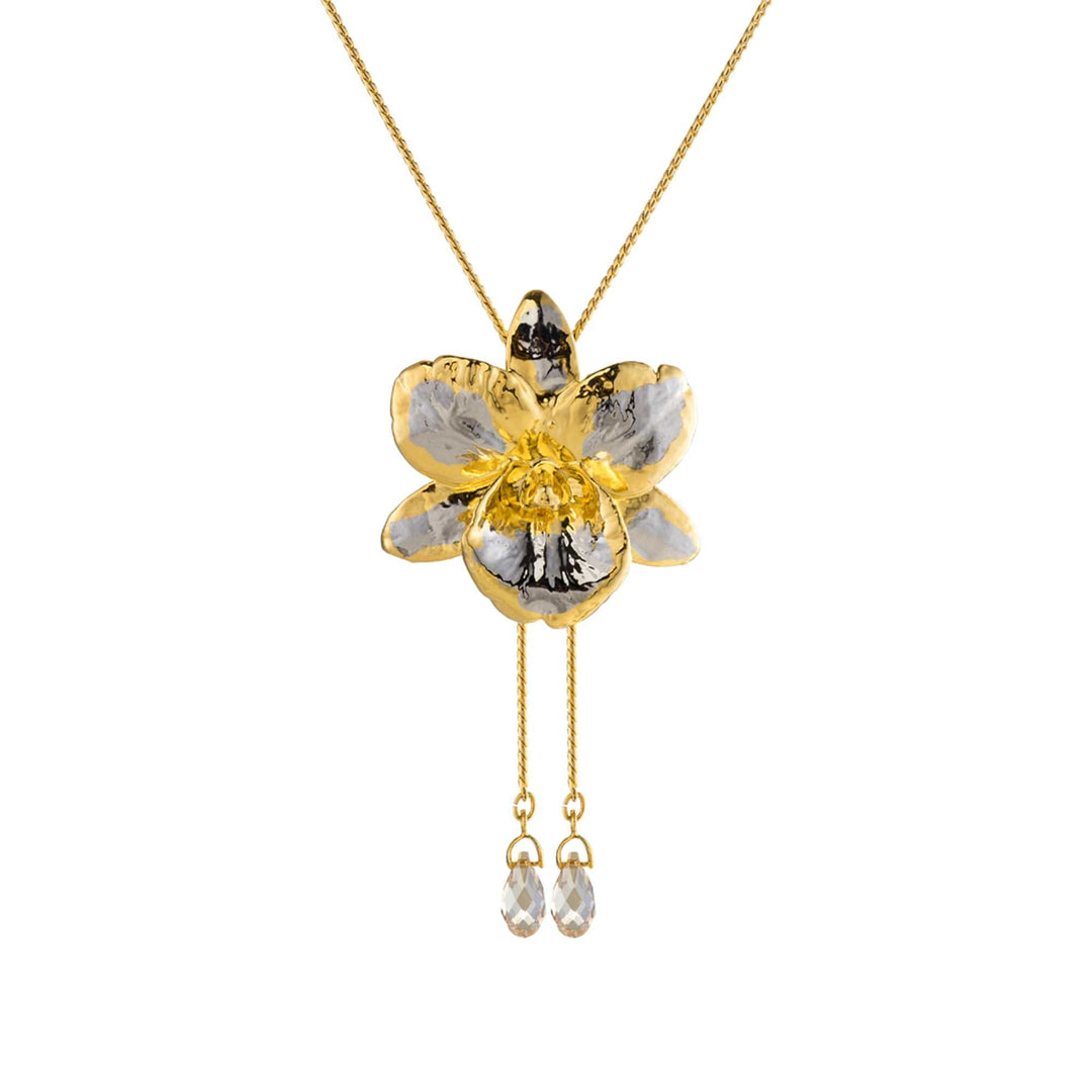 Risis Cattleya Orchid Slider Necklace with Crystal Tailend (PG) - A gold necklace with a five-petaled flower pendant, accented with silver hues and a central yellow crystal, has two smaller dangling clear crystals below it.