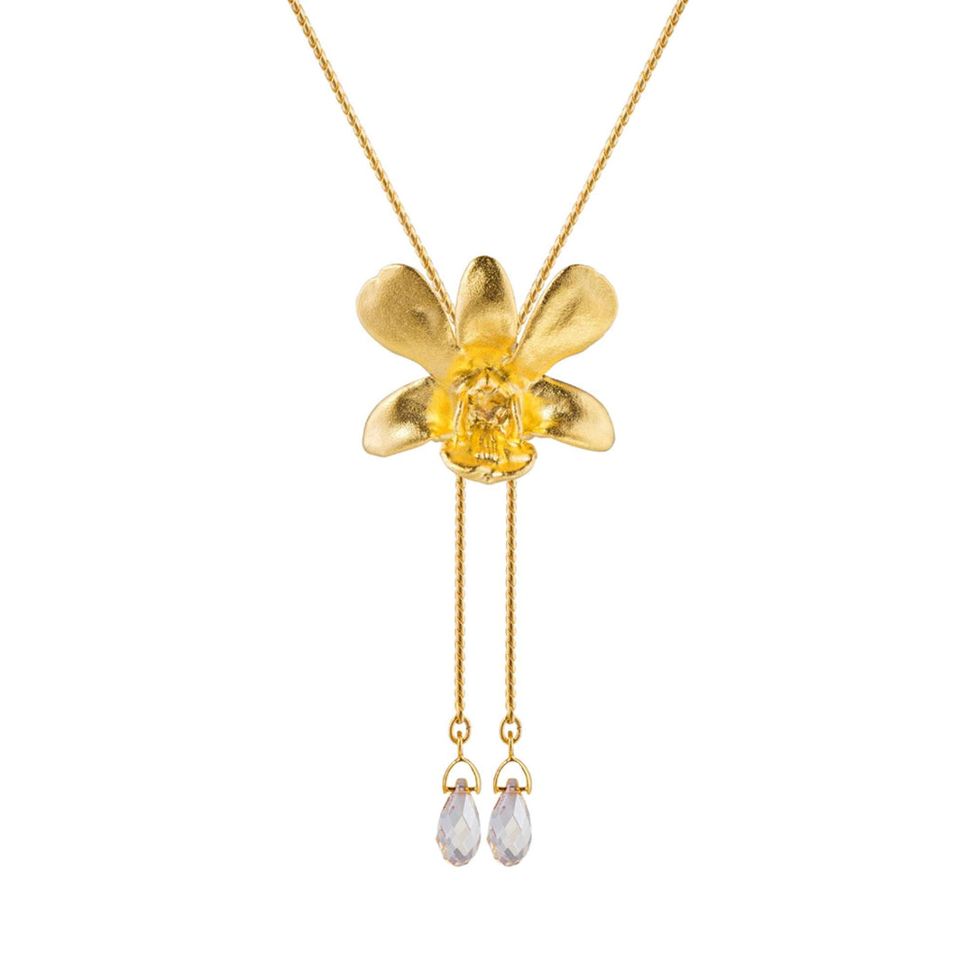 Risis Dendrobium Thong Chai Orchid Slider Necklace with Crystal Tailends (G) - A gold necklace with a matte flower pendant, centering a transparent yellow stone, and two clear teardrop crystals dangling below on delicate chains.