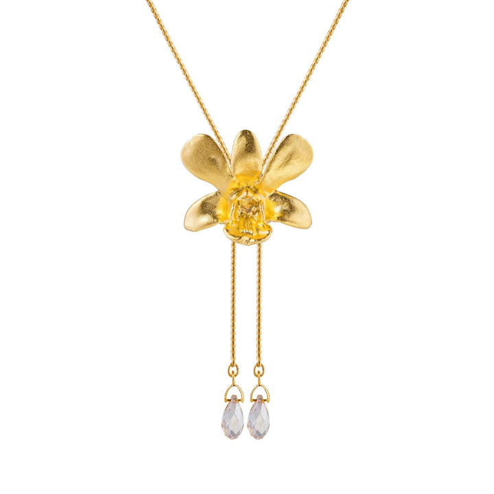 Risis Dendrobium Thong Chai Orchid Slider Necklace with Crystal Tailends (G) - A gold necklace with a matte flower pendant, centering a transparent yellow stone, and two clear teardrop crystals dangling below on delicate chains.