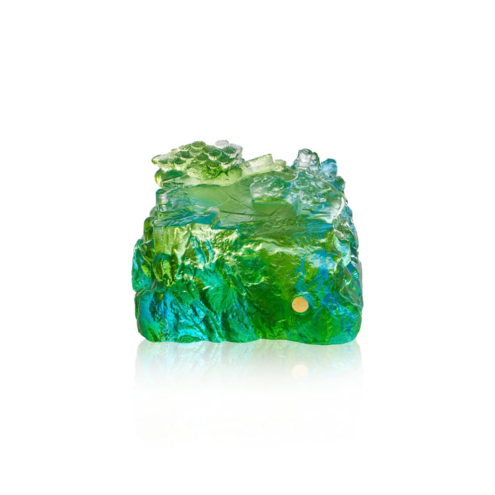 Risis Double Crane on Liu Li - A translucent, textured object with vibrant green and blue hues resembling rough, uncut gemstone with light reflecting off its irregular surface.