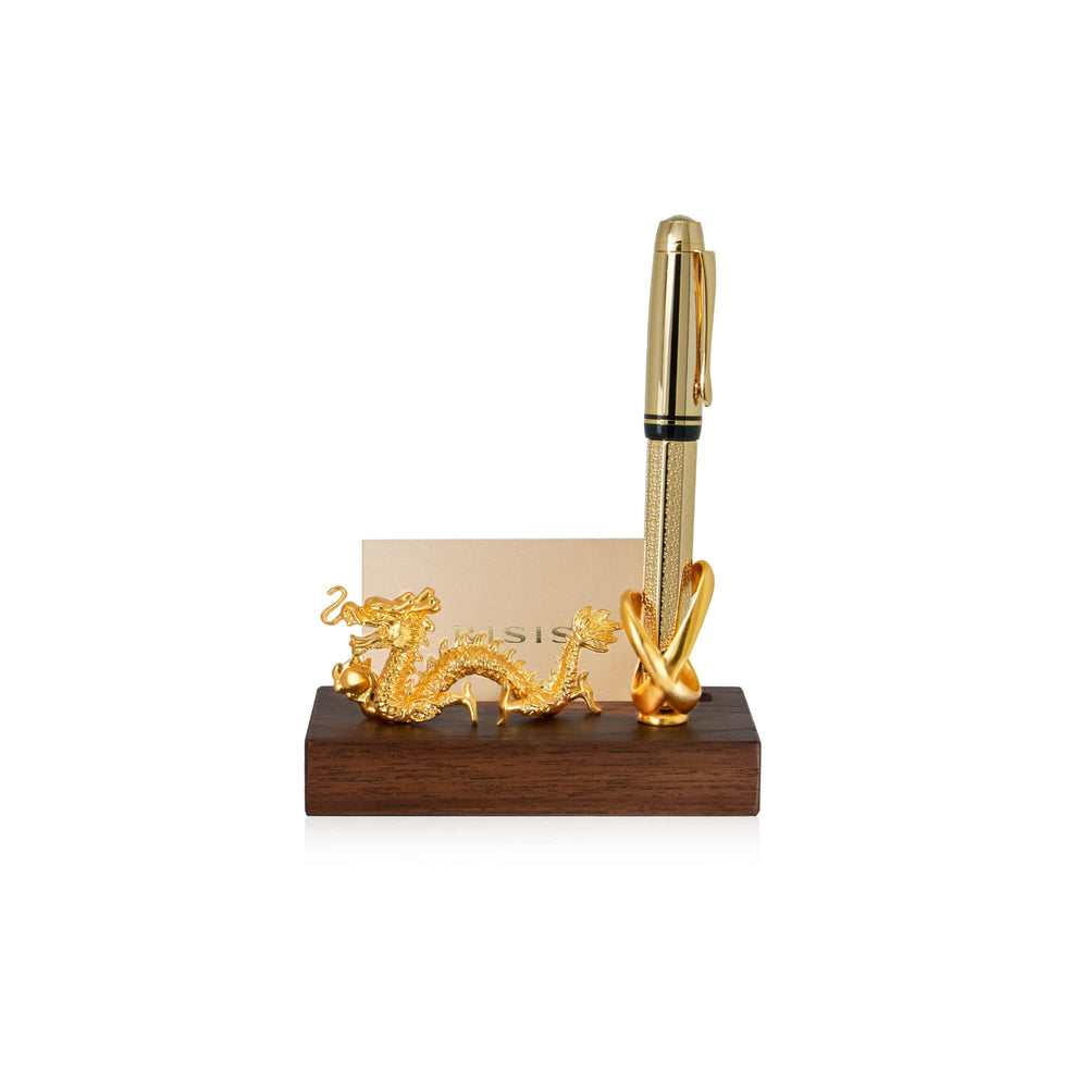 Risis Dragon Infinity Pen And Name Card Holder - A golden pen with intricate textures is paired with an ornate dragon-shaped holder beside a business card, all elegantly displayed on a polished wooden stand.