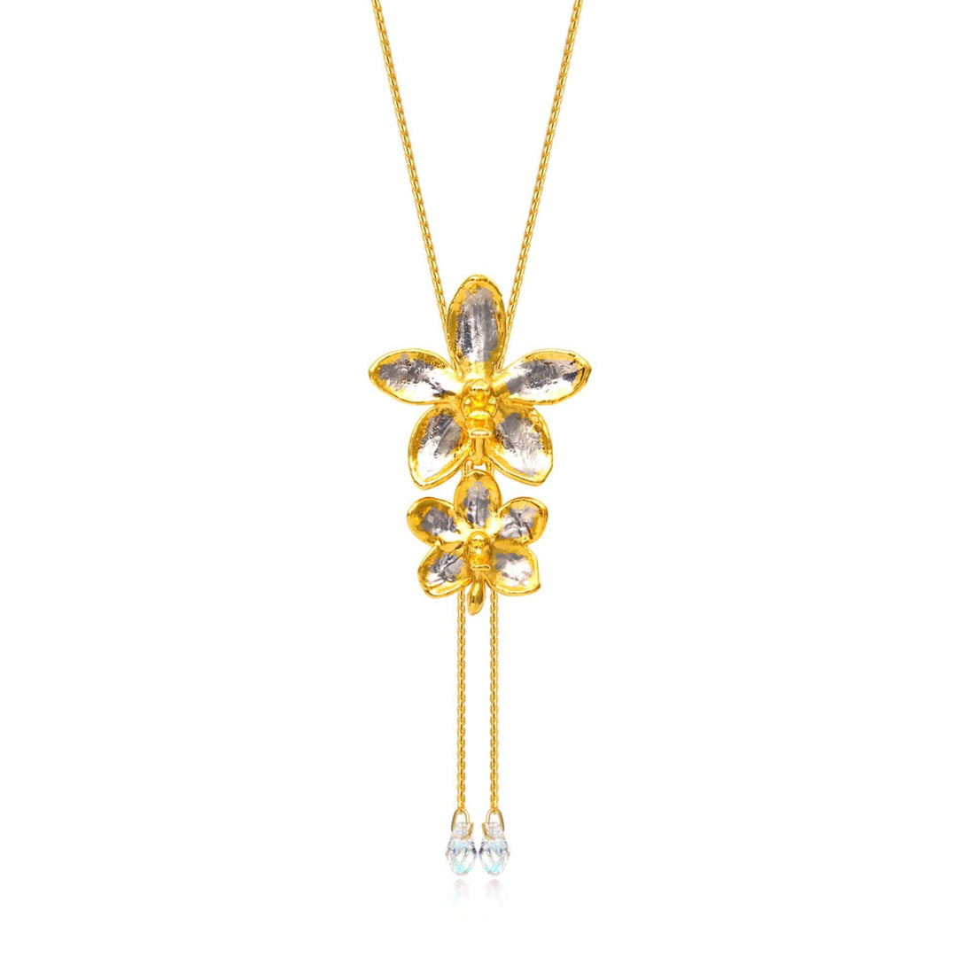 Risis Ascocenda Sagarik & Aeridovanda Vieng Ping Orchid Slider Necklace with Crystal Tailends (PG) - A golden necklace with a pendant shaped like two stacked flowers, adorned with clear gemstone petals, and two dangling chains ending in smaller gemstones.