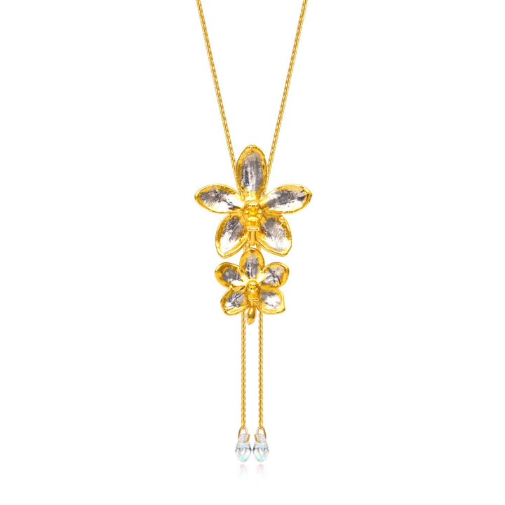Risis Ascocenda Sagarik & Aeridovanda Vieng Ping Orchid Slider Necklace with Crystal Tailends (PG) - A golden necklace with a pendant shaped like two stacked flowers, adorned with clear gemstone petals, and two dangling chains ending in smaller gemstones.