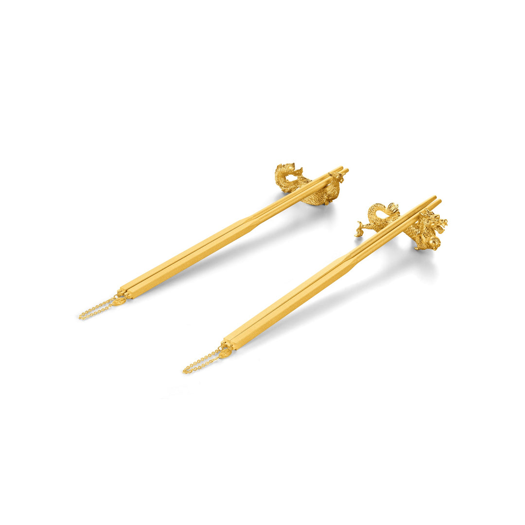 Risis Golden Chopsticks with Dragon and Phoenix Rests - Two golden hairpins with delicate, intricately designed dragon heads and chains at the ends, reflecting traditional Asian craftsmanship.