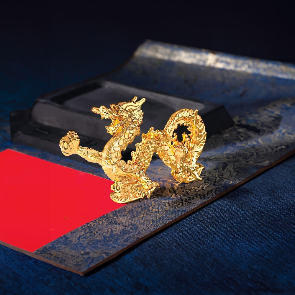 Risis Infinity Dragon - A golden dragon sculpture with intricate details and a lustrous finish stands prominently on a flat surface, exuding an aura of elegance and cultural significance.