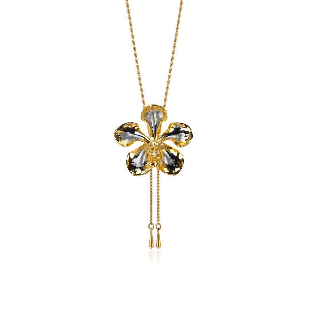 Risis Kagawara Firebird Orchid Slider Necklace (PG) - A gold necklace with a glossy, black and gold clover pendant, featuring two dangling chain tassels, suspended on a delicate chain.