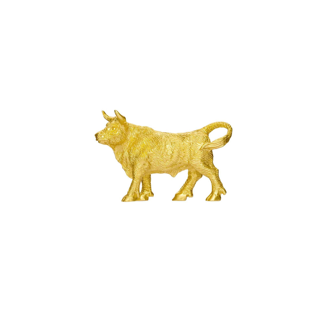 Risis Mini Orientals - Ox - A golden figurine of a bull, showcased in a walking stance with textured details, reflecting light off its smooth, shiny surface.