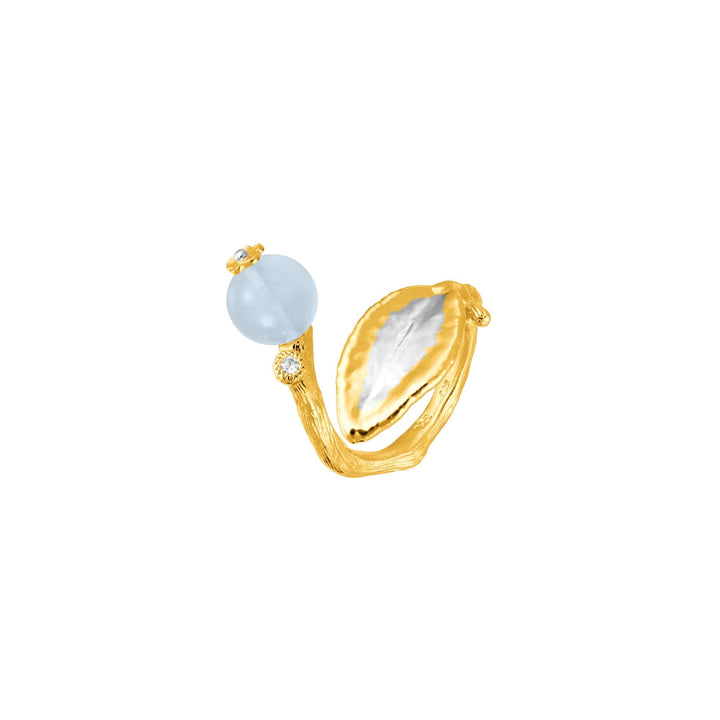 Risis Morning Glory Leaf Ring with Aquamarine and Topaz - This image depicts a gold-colored ring with a textured band, featuring a pale blue spherical gemstone and a small clear gem on one end, complementing a shell-shaped ornament on the other.