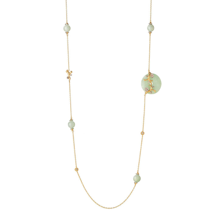 Risis Nature's Jade Long Necklace with White Topaz (L) - An elegant necklace with green gemstones and golden accents, featuring delicate interwoven leaves on a circular pendant, crafted in a hanging design.