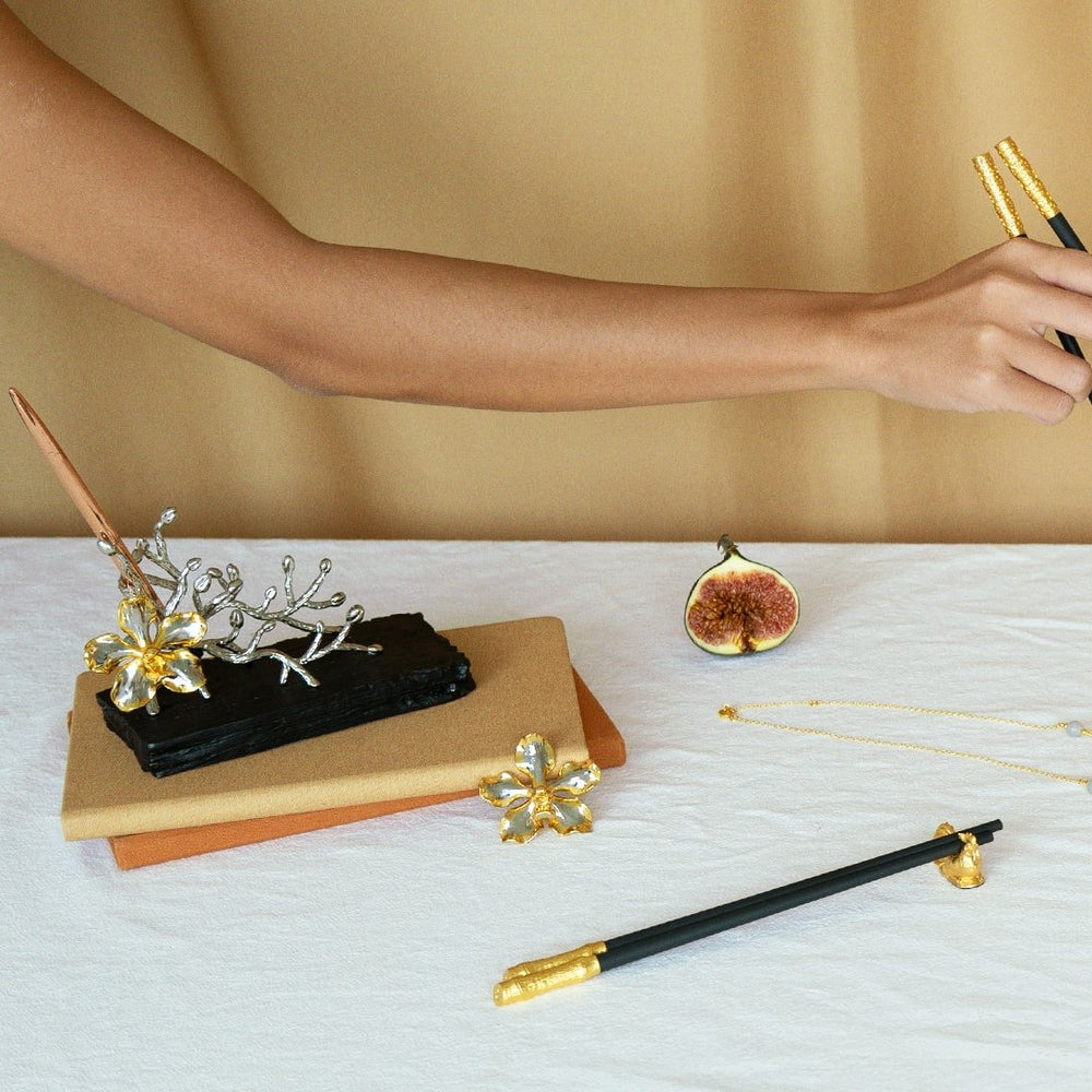 Risis Peranakan Chopsticks with Rest I - A gold-toned tie clip featuring a row of etched triangles within a polished rectangular frame.