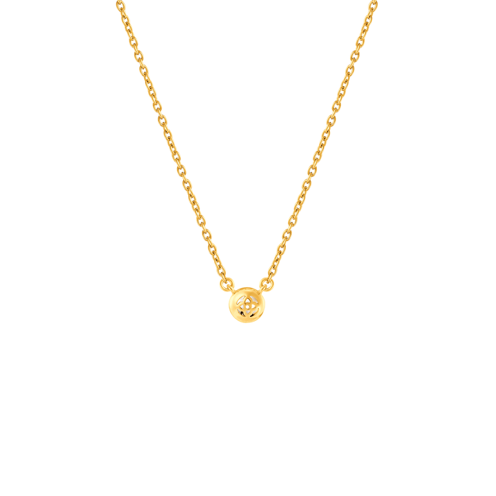 Risis Peranakan Jewel Necklace with Moonstone - A delicate gold necklace with a lustrous, simple, round pendant showcasing a cut-out geometric pattern, suspended centrally on a slender chain.