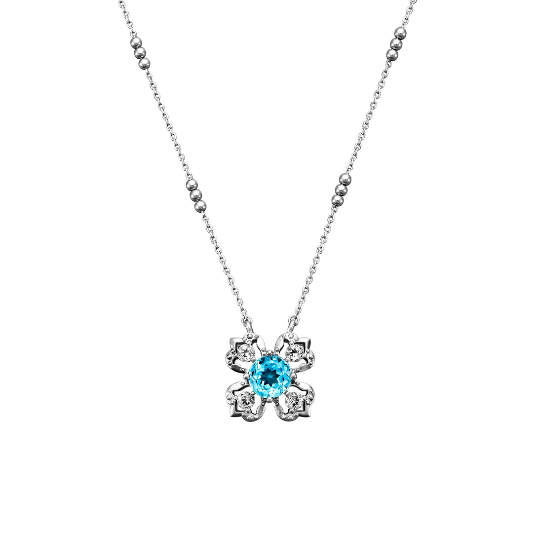 Risis Peranakan Kebaya Necklace (RH) with Sky Blue Topaz - A silver necklace with a detailed flower pendant, centering a sparkling aqua-blue gem surrounded by intricate petal-like designs.
