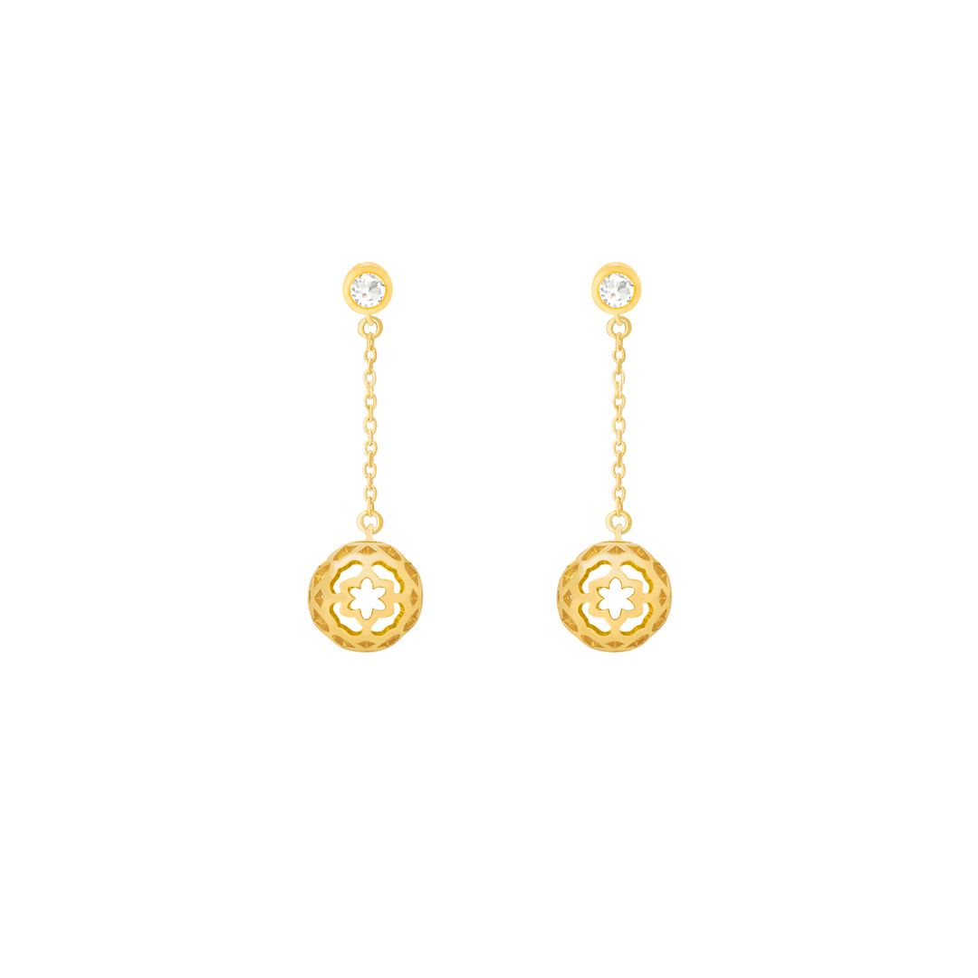 Risis Peranakan Spheres Dangling Earrings with White Topaz (G) - A pair of gold dangle earrings with a circular floral motif and a shiny gemstone at the earlobes.