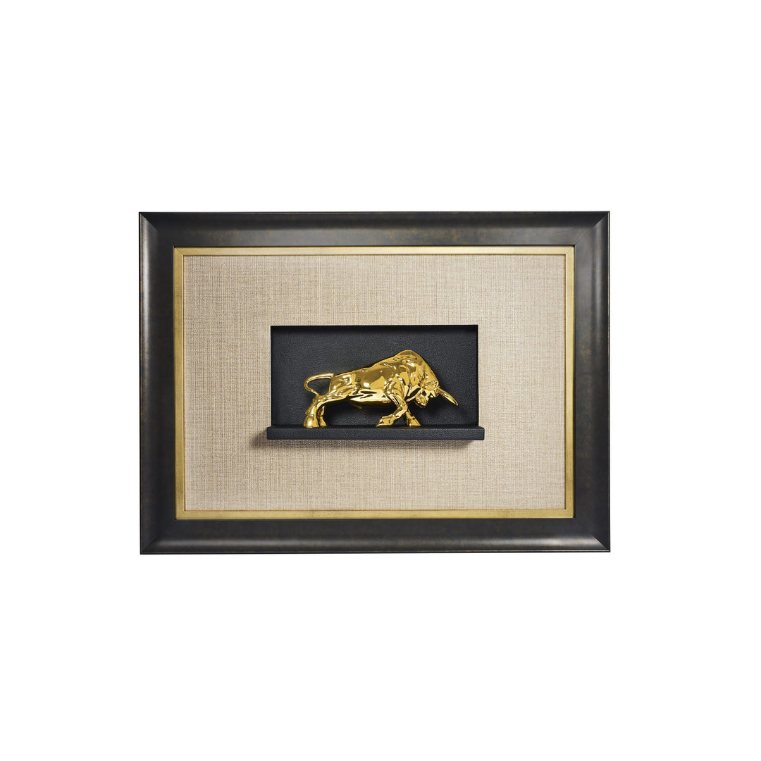 Risis Raging Bull in Black Frame - A golden bull sculpture is displayed, capturing dynamic movement, positioned against a fabric-lined shadow box framed elegantly in black with subtle gold accents.