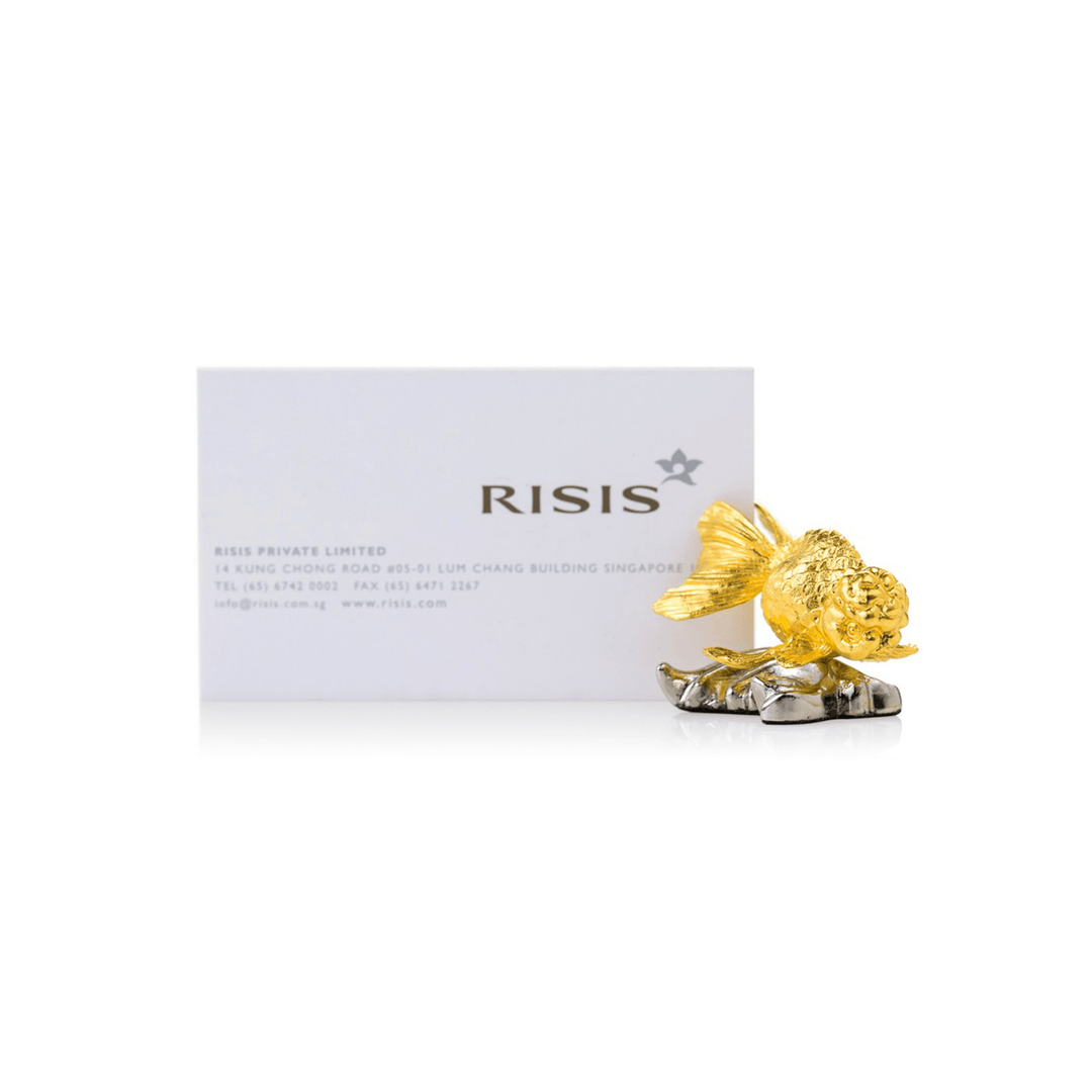 Risis Ranchu Goldfish Name Card Holder (Small) - A golden ornamental fish with intricate detailing sits on a metallic base, exuding elegance and craftsmanship. The sculpture is positioned in front of a business card.