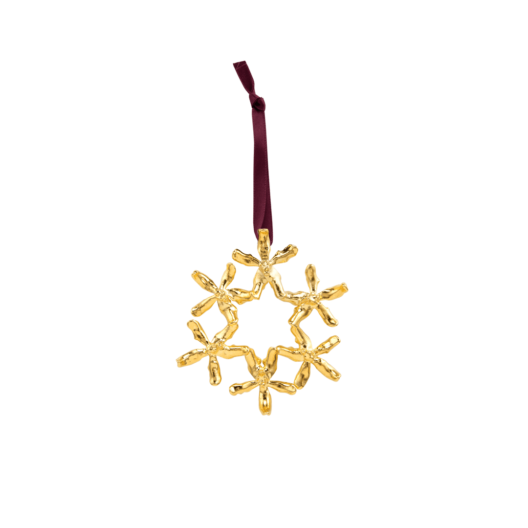 Risis Renantanda Sawadi Orchid Ornament (G) - A golden snowflake-shaped ornament dangles from a dark red ribbon, featuring intricate, glossy twists resembling ice crystals.