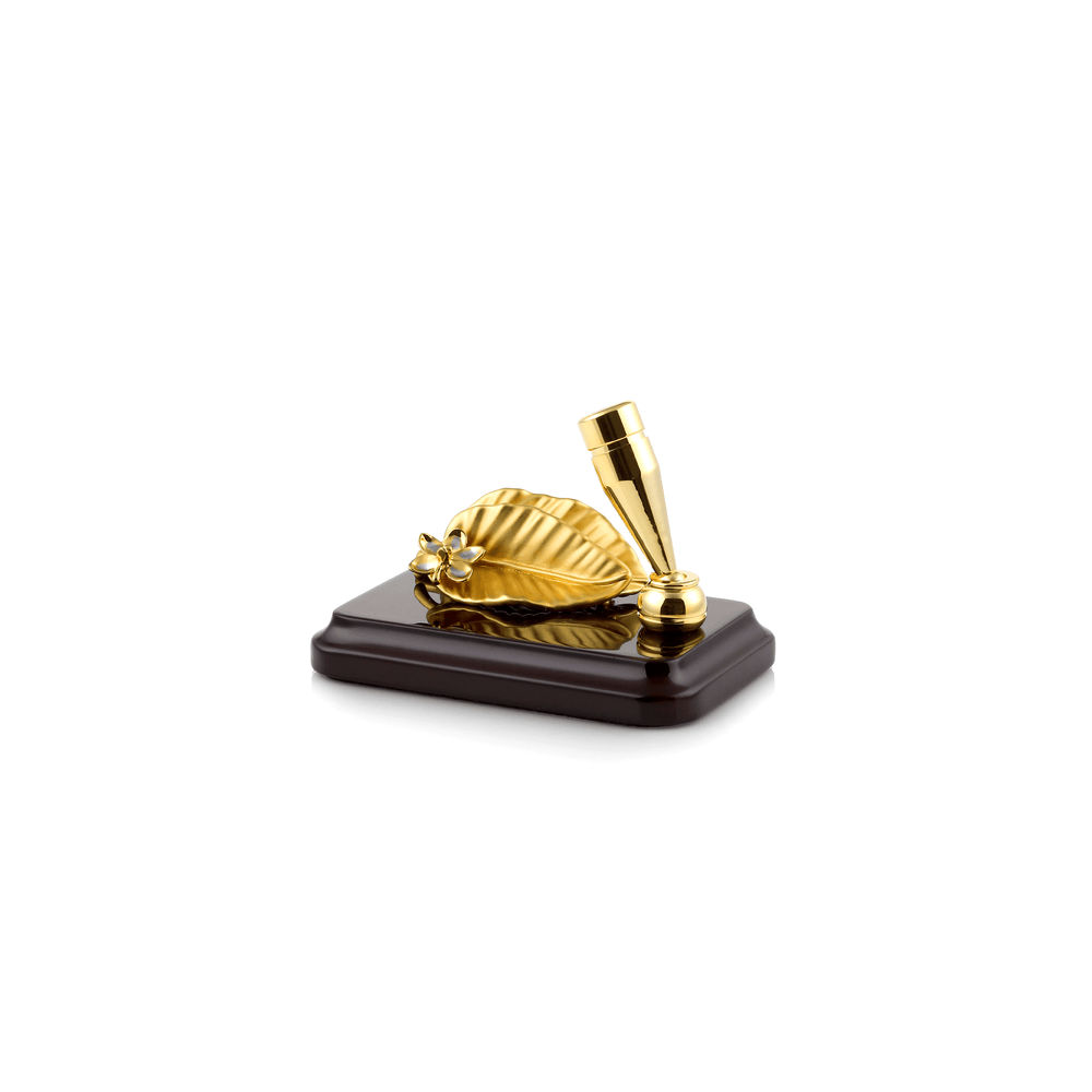 Risis Tropical Leaf Pen and Name Card Holder with Base - A golden shell with a blue gem centerpiece on a wooden base accompanied by a sleek, reflective gold lipstick tube on a white background.