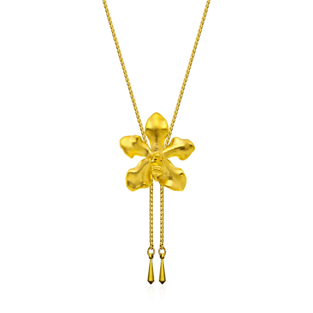 Risis Vanda Limbata Orchid Slider Necklace (G) - A shiny gold pendant shaped like a four-leaf clover; textured surface; two dangling elements below; suspended from a fine gold chain.