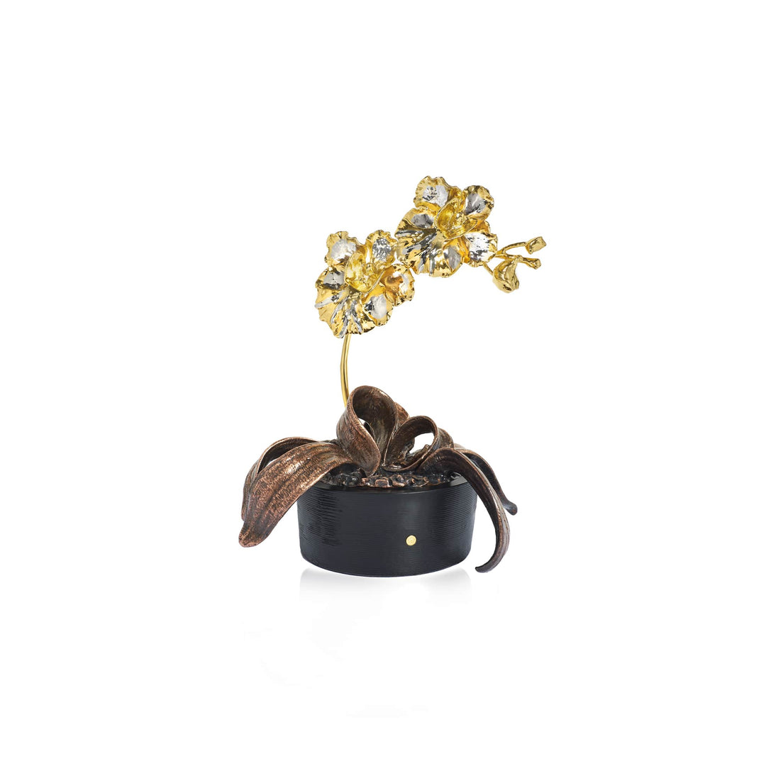 Risis Vanda Miss Joaquim Orchid In Pot - A golden flower sculpture with sparkling petals rises from a dark, textured base with curved, leaf-like elements, conveying elegance and craftsmanship.