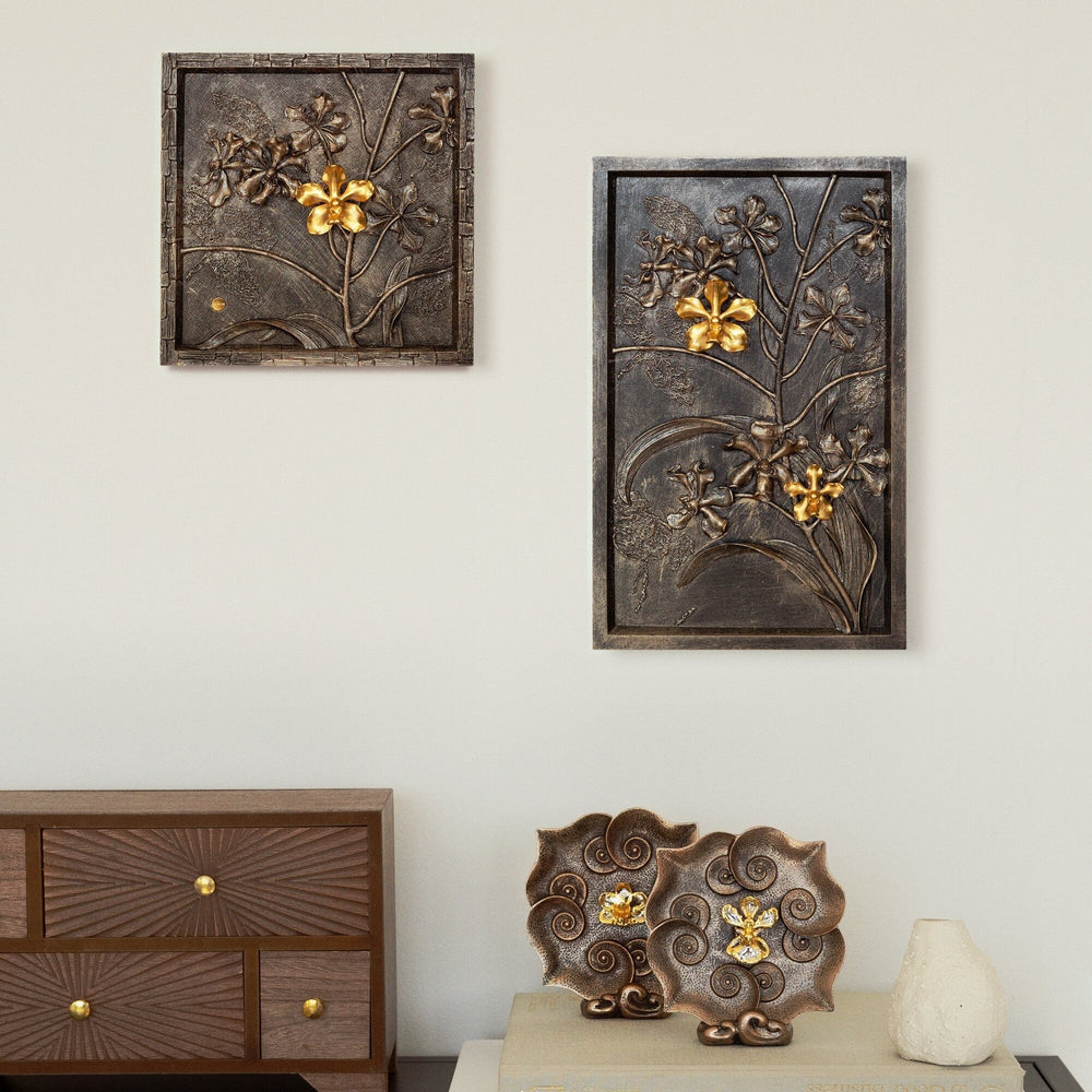 Risis Vanda Orchid Bronze Frame (L) - A golden flower-shaped ornament with shimmering petal surfaces is centrally displayed against a stark black square backdrop, framed by beige and gold borders.